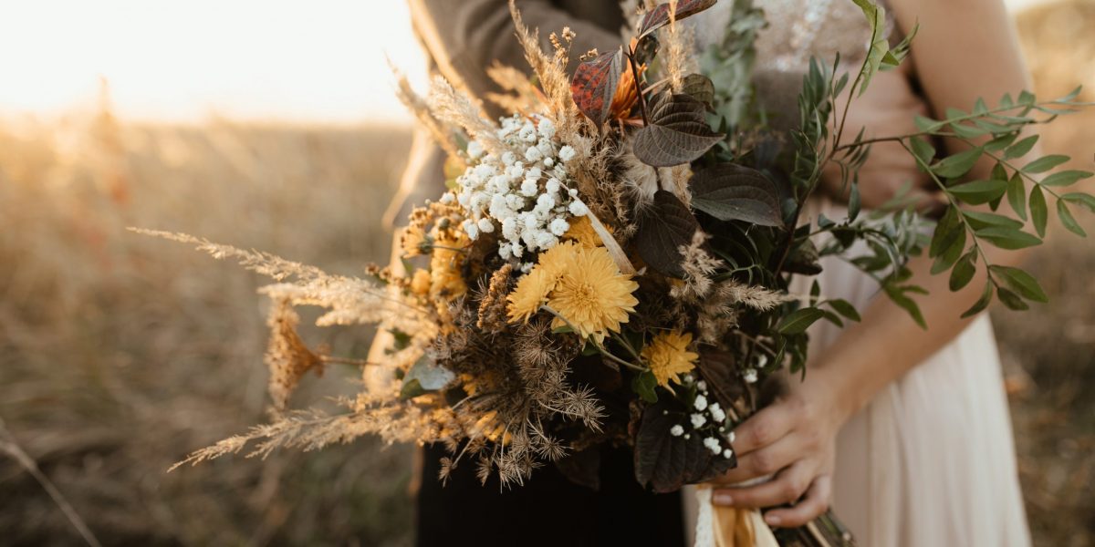 Beautiful bouquet of wild flowers in the hands of the bride Beautiful bouquet of wild flowers in the hands of the bride